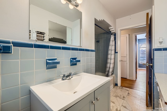 bathroom featuring shower / bath combo, tile walls, and vanity