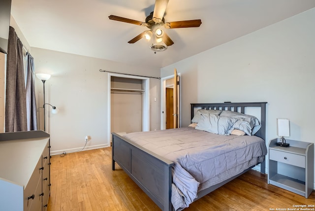 bedroom featuring light wood-type flooring, ceiling fan, and a closet