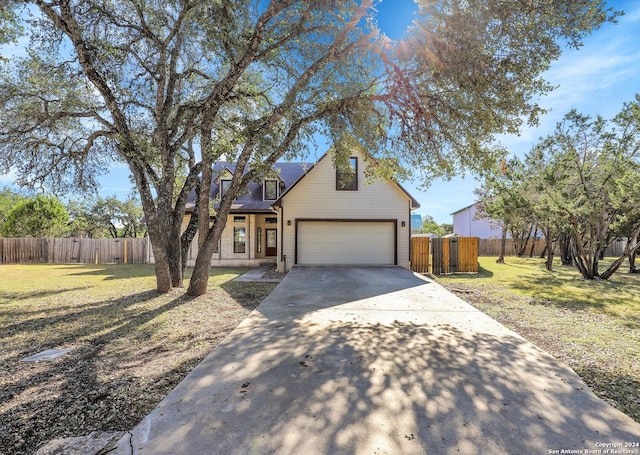 view of front of house with a garage and a front lawn