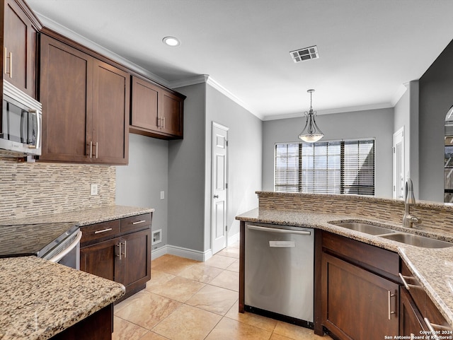 kitchen with light stone counters, ornamental molding, stainless steel appliances, dark brown cabinetry, and sink