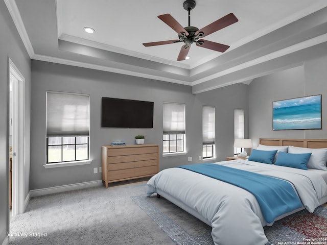 bedroom with ceiling fan, crown molding, a raised ceiling, and carpet floors