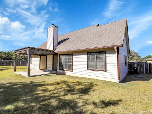 rear view of house with a pergola, a yard, and a patio area