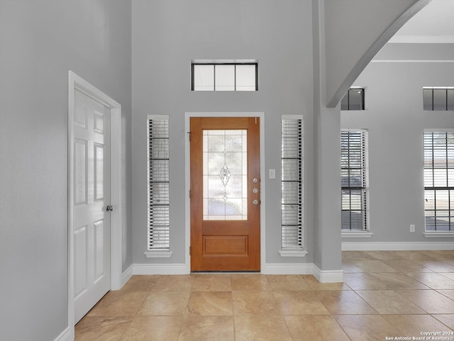 tiled foyer featuring a high ceiling