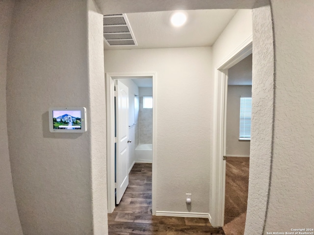 corridor featuring dark wood-type flooring