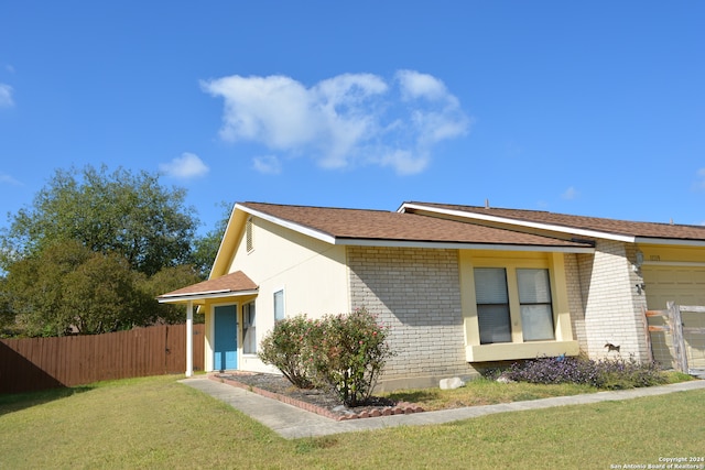 view of side of property with a yard