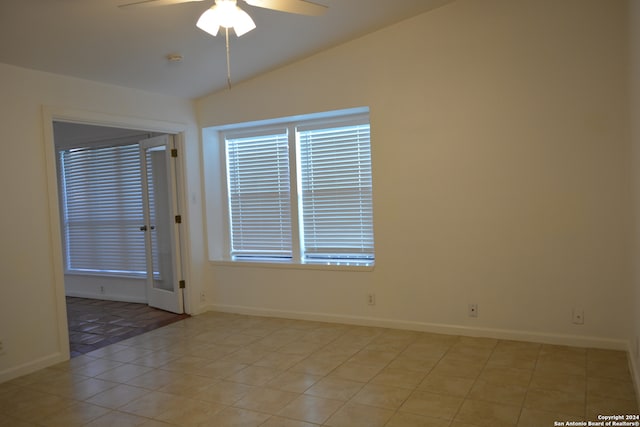 tiled spare room featuring ceiling fan and lofted ceiling