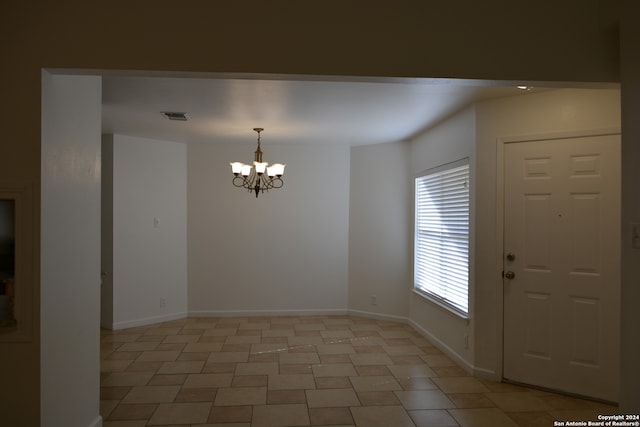 interior space featuring a notable chandelier and light tile patterned floors