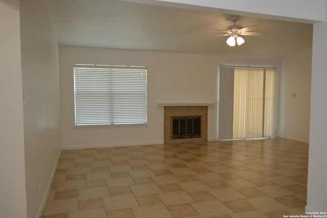 unfurnished living room featuring ceiling fan and light tile patterned floors