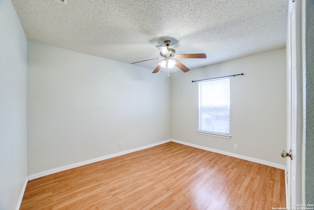 empty room featuring a textured ceiling, ceiling fan, and light hardwood / wood-style flooring