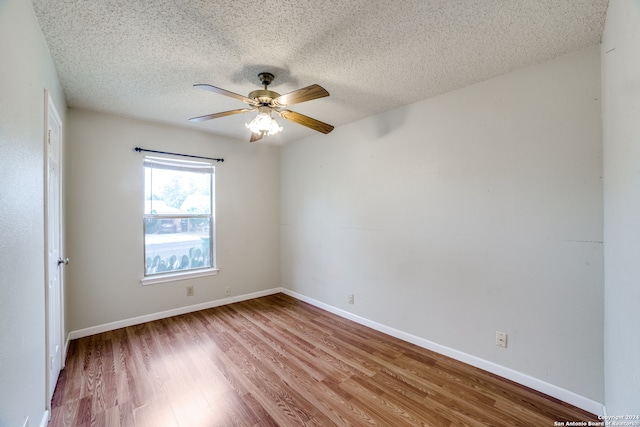 unfurnished room with a textured ceiling, ceiling fan, and light hardwood / wood-style flooring