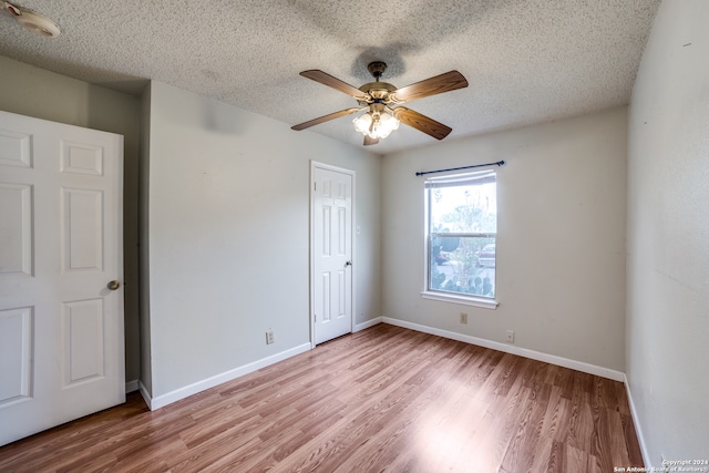 interior space featuring ceiling fan, a textured ceiling, and light hardwood / wood-style flooring