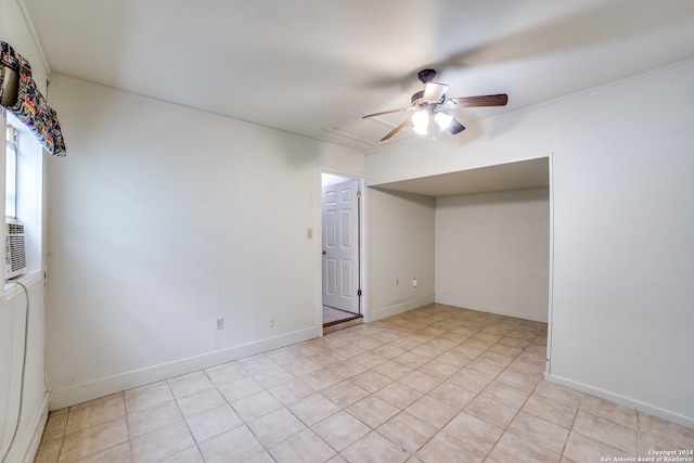 unfurnished room with ceiling fan and crown molding