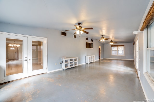 unfurnished living room with ceiling fan and french doors