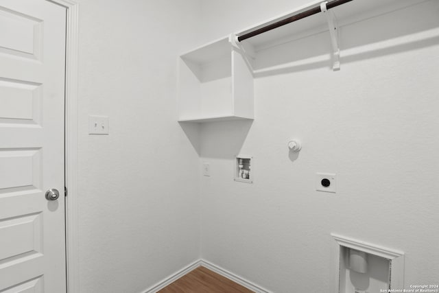 laundry room featuring hookup for a washing machine, hardwood / wood-style flooring, hookup for a gas dryer, and electric dryer hookup