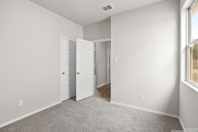 unfurnished bedroom with light carpet