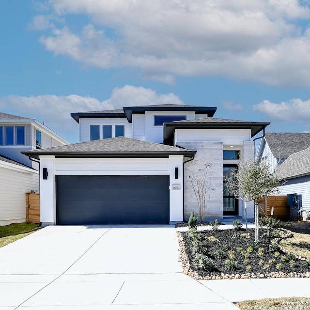 prairie-style house with an attached garage and driveway