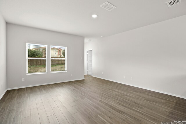 empty room with dark wood-type flooring