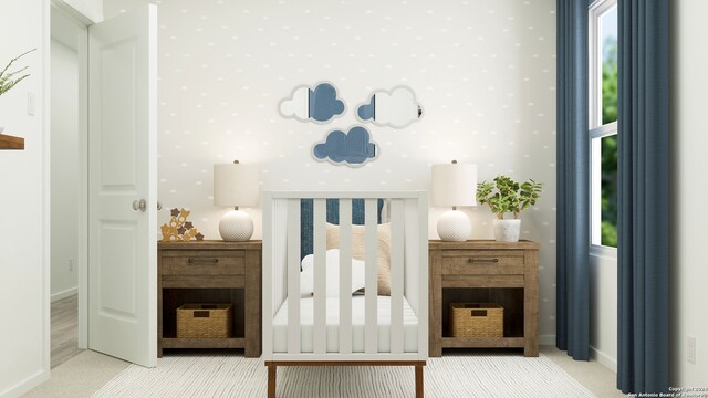 carpeted bedroom with a nursery area