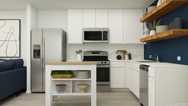 kitchen with white cabinets, light wood-type flooring, appliances with stainless steel finishes, and sink