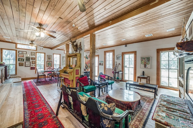 living room with a wealth of natural light and light hardwood / wood-style flooring