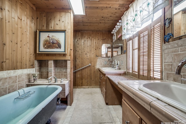 bathroom featuring vanity, wooden walls, wood ceiling, and a tub to relax in