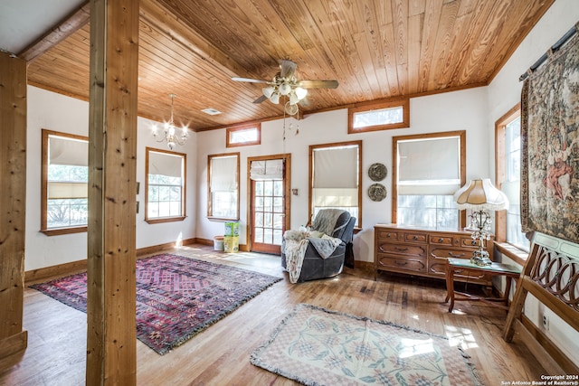 interior space with light wood-type flooring, wooden ceiling, and ceiling fan with notable chandelier