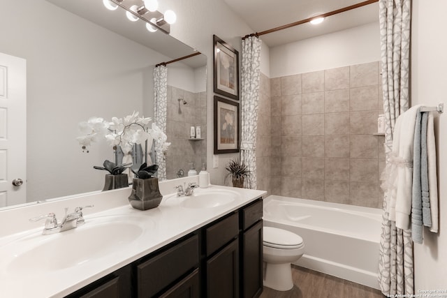 full bathroom featuring wood-type flooring, vanity, toilet, and shower / tub combo with curtain