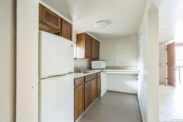 kitchen featuring sink and white appliances