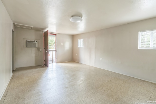 unfurnished room featuring a wall mounted air conditioner