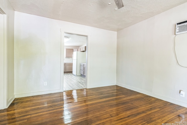 unfurnished room with dark hardwood / wood-style floors and a textured ceiling