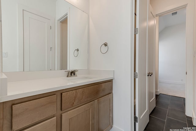 bathroom featuring tile patterned flooring and vanity