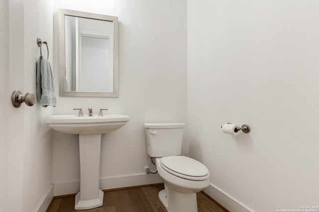 bathroom featuring hardwood / wood-style floors and toilet