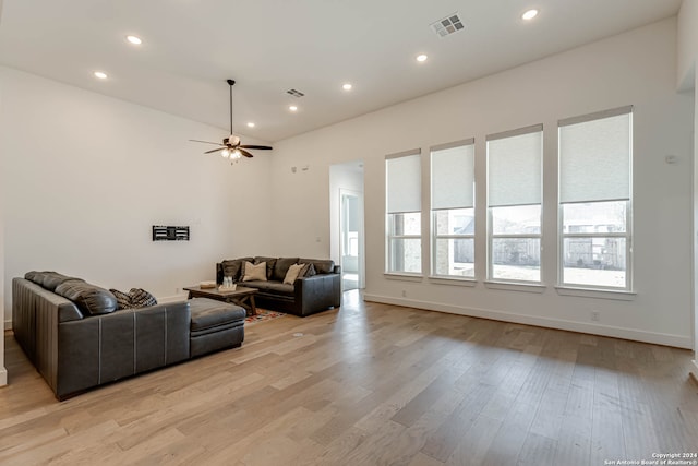 living room featuring ceiling fan and light hardwood / wood-style flooring