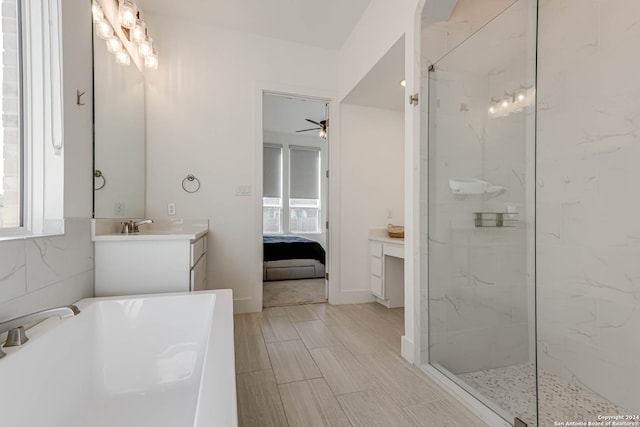 bathroom featuring tiled shower, ceiling fan, and vanity