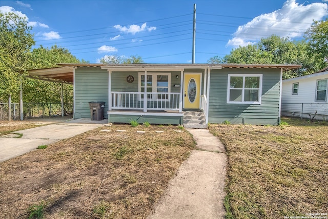 view of front facade featuring a carport and covered porch