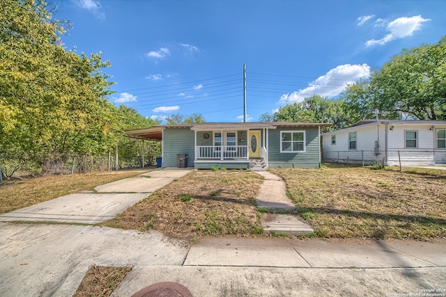 view of front of house with a porch and a carport