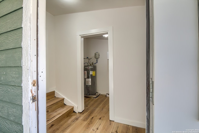 interior space featuring electric water heater and light hardwood / wood-style floors