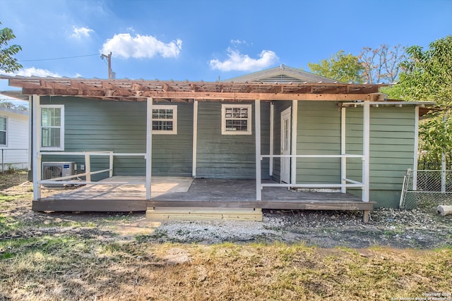 back of house featuring a wooden deck