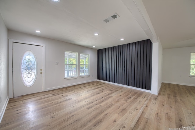 entrance foyer with a wealth of natural light and light hardwood / wood-style flooring