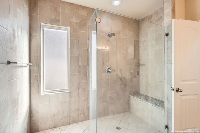 bathroom with walk in shower and tile patterned floors