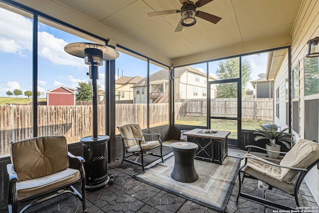 sunroom / solarium with a wealth of natural light and ceiling fan