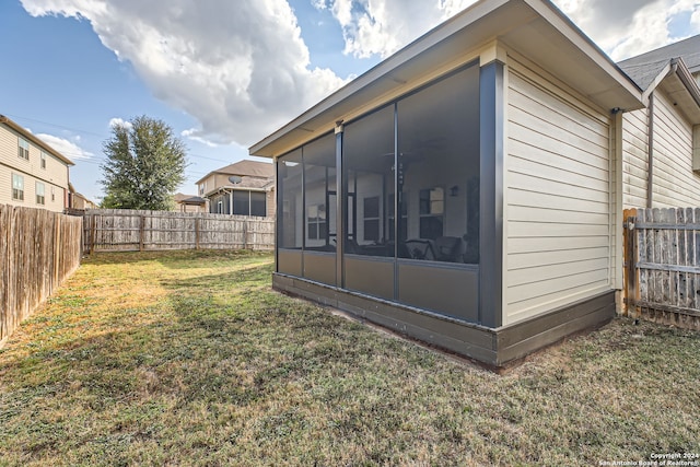 exterior space featuring a lawn and a sunroom