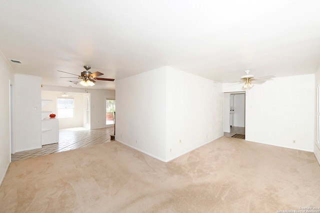 carpeted empty room with ceiling fan