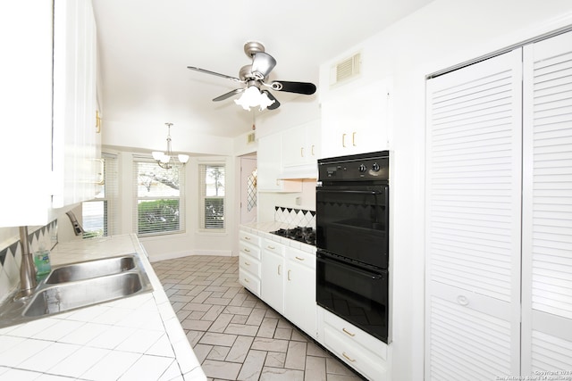 kitchen with tile countertops, white cabinetry, sink, and black appliances