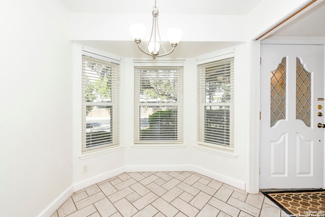 unfurnished dining area featuring light tile patterned floors and a notable chandelier