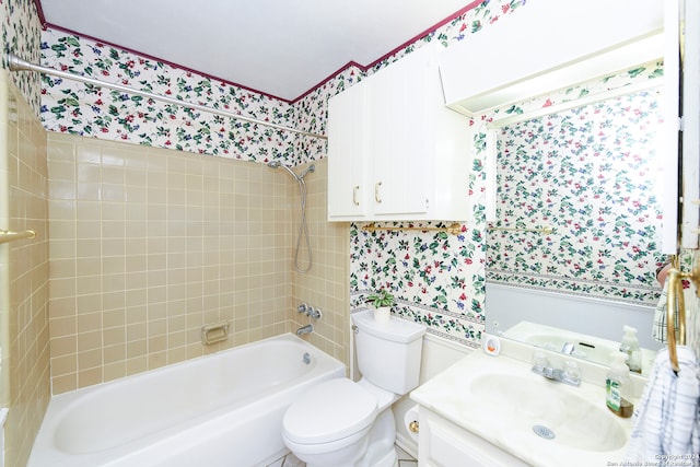 full bathroom featuring vanity, tiled shower / bath, and toilet