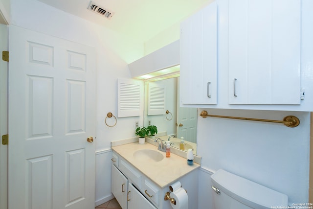 bathroom with vanity, tile patterned floors, and toilet