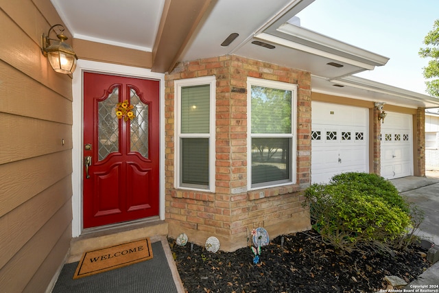 doorway to property featuring a garage