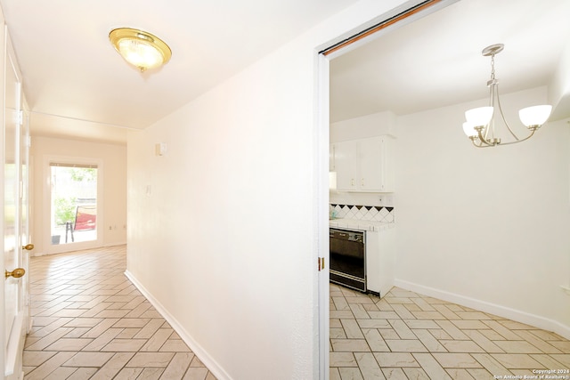 corridor featuring a notable chandelier