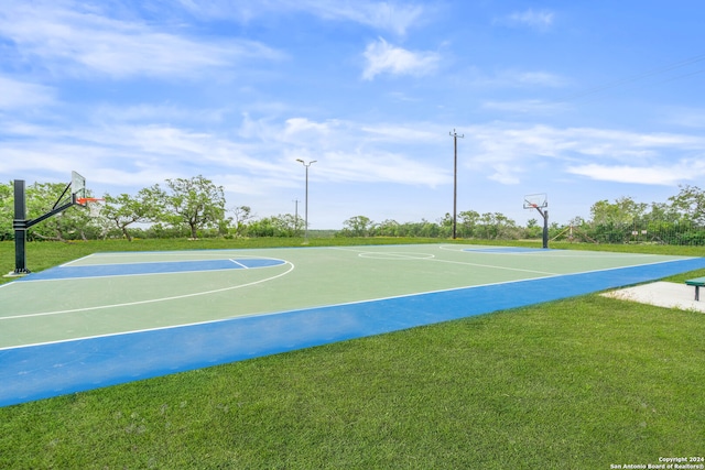 view of basketball court with a yard